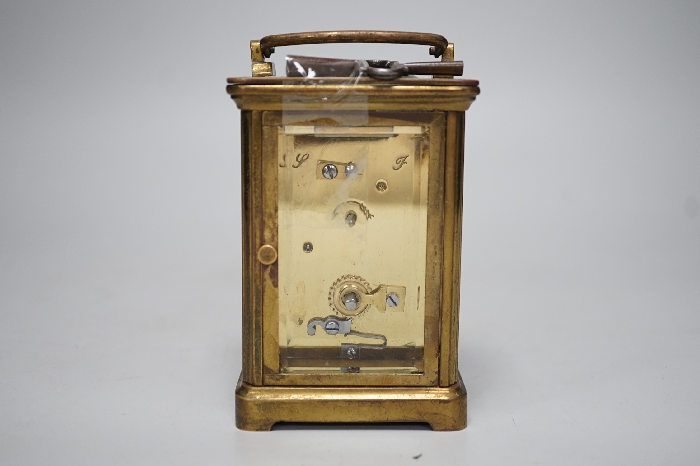 A 19th century brass carriage timepiece with black Roman numerals and second markers over a white dial